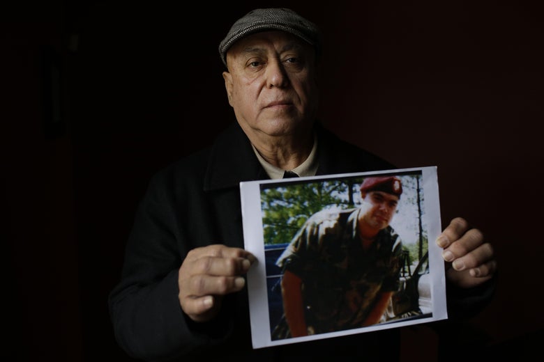 Miguel Perez poses as he holds a photo of his son Miguel Perez Jr., on April 4, 2017 in Chicago, Illinois.Perez Jr., an Army veteran is facing deportation after serving seven years in a state penitentiary on a drug charge.